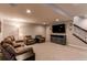 Spacious basement with plush carpet, large television, and a comfortable seating area at 3367 New Haven Cir, Castle Rock, CO 80109