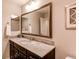 Modern bathroom vanity with granite countertop, dark wood cabinets, and decorative mirror at 3367 New Haven Cir, Castle Rock, CO 80109