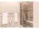 Bright bathroom featuring tiled shower with glass door and decorative tile accent at 3367 New Haven Cir, Castle Rock, CO 80109