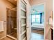 Stylish bathroom featuring a glass-enclosed shower, modern fixtures, and a glimpse of the bedroom at 3367 New Haven Cir, Castle Rock, CO 80109