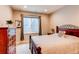 Cozy bedroom with natural light, featuring a wrought iron bed frame and a wooden dresser at 3367 New Haven Cir, Castle Rock, CO 80109