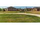 A green park with a bench, community pergola, and residential homes on a sunny day at 3367 New Haven Cir, Castle Rock, CO 80109