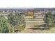 An expansive view from the green hillside towards the neighborhood, pond, and community park at 3367 New Haven Cir, Castle Rock, CO 80109
