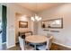 Cozy dining room featuring a round table, chandelier, and tasteful decor with wood flooring at 3367 New Haven Cir, Castle Rock, CO 80109