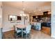 Well-lit dining area with elegant chandelier, wooden floors and ample seating at 3367 New Haven Cir, Castle Rock, CO 80109
