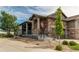 Beautiful exterior of a stone-accented home with landscaped yard and charming front porch at 3367 New Haven Cir, Castle Rock, CO 80109