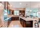 Spacious kitchen with a central island, dark wood cabinets, and open layout to the living area at 3367 New Haven Cir, Castle Rock, CO 80109