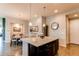 Modern kitchen boasts an island with granite countertops and pendant lighting adjacent to dining area at 3367 New Haven Cir, Castle Rock, CO 80109
