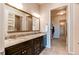Elegant main bathroom with double sinks, granite countertops, and a glimpse into the walk-in closet at 3367 New Haven Cir, Castle Rock, CO 80109