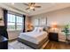 Serene bedroom with tray ceilings, a ceiling fan, and a large window showcasing scenic views at 3367 New Haven Cir, Castle Rock, CO 80109