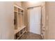 Functional mudroom features built-in cubbies, seating and a sliding closet door at 3367 New Haven Cir, Castle Rock, CO 80109