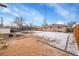 Large backyard featuring a trampoline, wood fence, and small sandbox at 1281 Myrtle St, Brighton, CO 80601