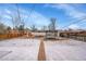 Spacious backyard featuring a trampoline, shed and snow-covered ground at 1281 Myrtle St, Brighton, CO 80601