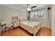 Bright bedroom with hardwood floors, a ceiling fan, and a large window at 1281 Myrtle St, Brighton, CO 80601