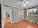 Empty bedroom with hardwood floors, a ceiling fan, and a bright window at 1281 Myrtle St, Brighton, CO 80601