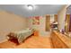 Bedroom features a single bed, wooden dresser, and light hardwood floors at 1281 Myrtle St, Brighton, CO 80601