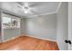 Empty bedroom with hardwood floors, a ceiling fan, and a bright window at 1281 Myrtle St, Brighton, CO 80601