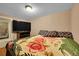 Cozy bedroom featuring a television, closet, and floral bedspread at 1281 Myrtle St, Brighton, CO 80601