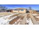 Cozy one-story home boasts a brick and wood exterior, large driveway, and well-kept yard at 1281 Myrtle St, Brighton, CO 80601