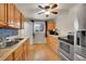 This lovely kitchen has stainless steel appliances, tile backsplash, and wood cabinets at 1281 Myrtle St, Brighton, CO 80601