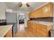 This kitchen includes stainless steel appliances, tile backsplash, and wood cabinets at 1281 Myrtle St, Brighton, CO 80601