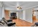 The living room includes wood floors, TV, and doorways into other rooms at 1281 Myrtle St, Brighton, CO 80601