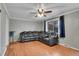 The cozy living room includes wood floors, a ceiling fan, and a large reclining sectional at 1281 Myrtle St, Brighton, CO 80601