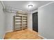 Small, gray room featuring light hardwood floors and built-in shelves at 1281 Myrtle St, Brighton, CO 80601