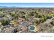An aerial view of a neighborhood, highlighting a community pool and townhomes at 6730 W 84Th Cir # 96, Arvada, CO 80003