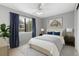 Bright bedroom featuring a ceiling fan and an exterior view through a window at 6730 W 84Th Cir # 96, Arvada, CO 80003