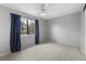 Bright bedroom with a ceiling fan and natural light streaming through the window with a leafy view at 6730 W 84Th Cir # 96, Arvada, CO 80003
