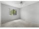 Bright bedroom with a ceiling fan, window, neutral carpet, and light-colored walls at 6730 W 84Th Cir # 96, Arvada, CO 80003
