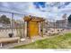 Charming community garden entrance with wooden pergola, benches, and greenery at 6730 W 84Th Cir # 96, Arvada, CO 80003