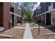 Landscaped walkway showcasing townhouses with gravel and concrete paths leading to residences at 6730 W 84Th Cir # 96, Arvada, CO 80003