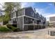 Townhouses with gray siding, balconies, and garages on a sunny day showcasing contemporary architecture at 6730 W 84Th Cir # 96, Arvada, CO 80003