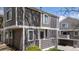 A charming townhouse with gray siding, a small porch, and white trim around the windows at 6730 W 84Th Cir # 96, Arvada, CO 80003