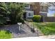 Landscaped front with stairs leading to a gray townhouse, sign for 6730 W 86th Cir address at 6730 W 84Th Cir # 96, Arvada, CO 80003