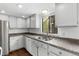 Well-lit kitchen featuring white cabinetry, granite countertops, and a stainless steel sink beneath a window at 6730 W 84Th Cir # 96, Arvada, CO 80003