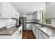 Modern kitchen featuring white cabinets, stainless steel appliances, and hardwood floors at 6730 W 84Th Cir # 96, Arvada, CO 80003
