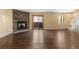 Spacious living room featuring a cozy fireplace, wood floors, and a sliding glass door to patio at 6730 W 84Th Cir # 96, Arvada, CO 80003