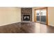 Bright living room with hardwood floors, stone fireplace, and natural light from the sliding patio door at 6730 W 84Th Cir # 96, Arvada, CO 80003