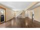 Spacious living room with hardwood floors, a staircase, and natural light from a sliding glass door at 6730 W 84Th Cir # 96, Arvada, CO 80003