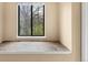 Cozy window seat nook with tile flooring provides a serene space for relaxation and reading at 6730 W 84Th Cir # 96, Arvada, CO 80003