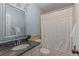 Bathroom featuring a mirror, granite countertop, wooden cabinets, and shower at 7975 S Gaylord Way, Centennial, CO 80122