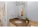 Bathroom featuring a framed mirror, granite countertop, and wooden cabinets at 7975 S Gaylord Way, Centennial, CO 80122