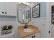 Charming bathroom with vanity, decorative mirror, wainscoting, and butterfly wall art at 7975 S Gaylord Way, Centennial, CO 80122