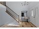 Welcoming foyer featuring staircase, neutral walls, and decorative tile flooring at 7975 S Gaylord Way, Centennial, CO 80122