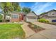 Charming single Gathering home with a well-manicured front yard and a red front door at 7975 S Gaylord Way, Centennial, CO 80122