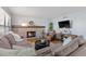 Inviting living room featuring a brick fireplace, hardwood floors, and plush seating at 7975 S Gaylord Way, Centennial, CO 80122