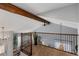 Open loft space with hardwood railing, accent beams, and natural light at 7975 S Gaylord Way, Centennial, CO 80122